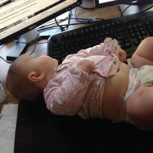 Baby on the desk at work after a diaper change